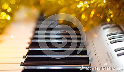 The piano is decorated with Christmas shiny garlands. Music on New Year`s night_ Stock Photo