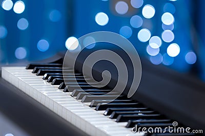 Piano keys on a blue bokeh background Stock Photo