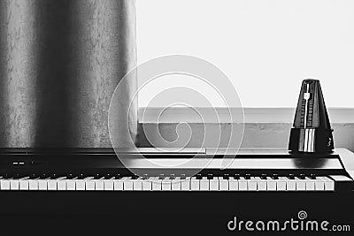 Piano with metronome. Music instrument. Art and abstract background Stock Photo