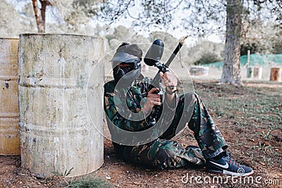 Man Playing Paintball in the forest Editorial Stock Photo