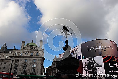 Piccadilly circus in London, England, United Kingdom. View to the monument, english architecture and screens. Editorial Stock Photo