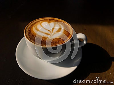 A Piccolo Coffee with sun Stock Photo