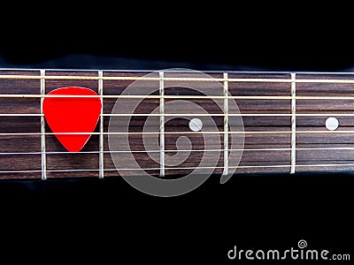 Pick guitar on finger board background Stock Photo
