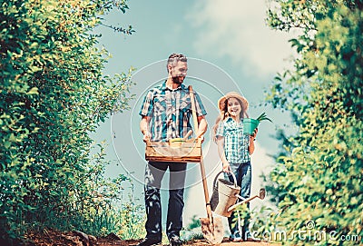 Pick out flats favorite plants. Garden works. Spring garden. Spring gardening checklist. Father and daughter with shovel Stock Photo