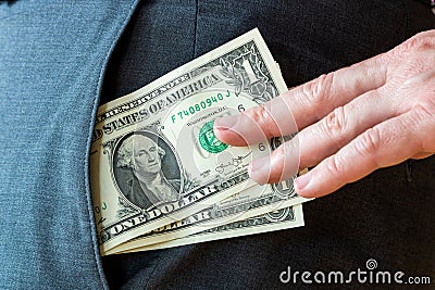 Pick pocket - stealing dollar bills out of a pocket Stock Photo