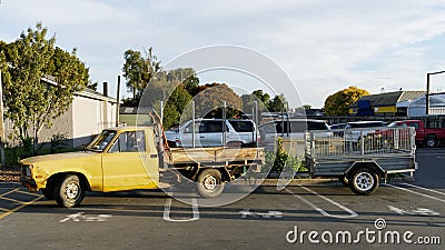 A pick up truck and trailer parked across three push chair and baby parking bays Stock Photo