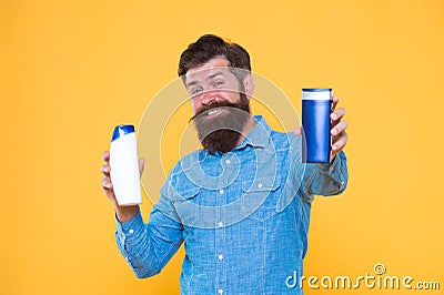 Picking proper remedy. Liquid soap. Bath cosmetics. Which one is better. Man hold shampoo bottles. Hair care. Shampoo Stock Photo