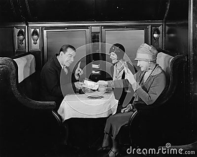 Picking up the tab in train dining car Stock Photo