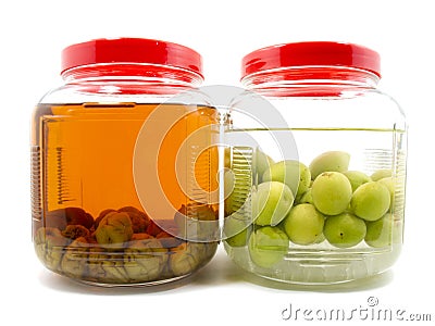 Before and after pickle plum liqueur in glass jar Stock Photo