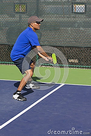 Pickleball Action - Man in Blue Guarding the Sideline During A Match Stock Photo