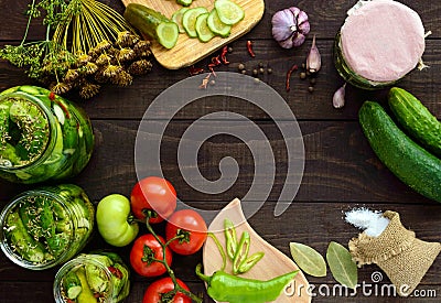 Pickled cucumbers in glass jars. Spices and vegetables for preparation of pickles. Stock Photo