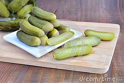 Pickled cucumbers on wooden board Stock Photo