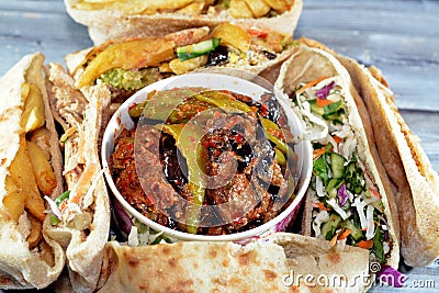 Pickled fried aubergine and green peppers, Traditional Egyptian popular breakfast street sandwiches of mashed fava beans, fried Stock Photo