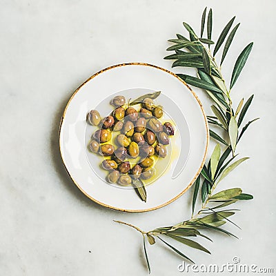 Pickled green Mediterranean olives in virgin olive oil, square crop Stock Photo