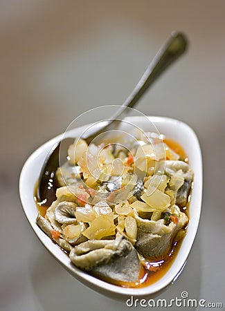 Pickled herring rolls in bowl Stock Photo