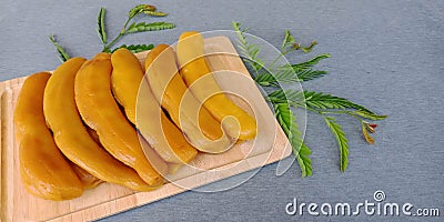 Pickled tamarind : preserved sweet tamarind fruit on gray background. Stock Photo