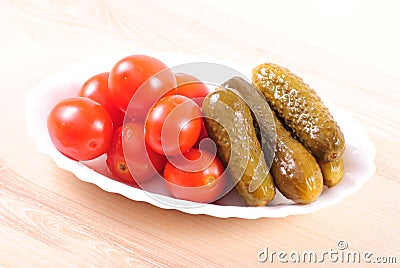 Pickled tomatoes and cucumbers Stock Photo