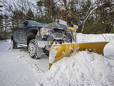 Pickup truck plowing snow Stock Photo