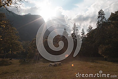 A picnic area or place in a beautiful valley sourounded by mountains in the sunset Stock Photo