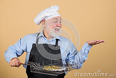 Picnic and barbecue concept. Bbq concept. Barbeque and smoked dish. Grilling food. Mature bearded chef hold grilling Stock Photo