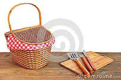 Picnic Basket And Grill Tools On The Outdoor Table Isolated Stock Photo