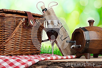 Picnic basket on the table with glass of wine and tun Stock Photo
