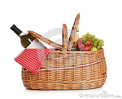 Picnic basket with wine and fruit on white Stock Photo