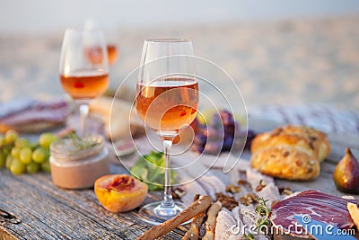 Picnic on the beach at sunset in boho style, food and drink conc Stock Photo