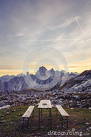 Picnic bench in stunning alpine scenery at sunset. The mountain Stock Photo