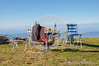 Picnic and camping equipment, table and chairs on the top of the mount Stock Photo