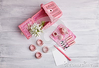 Picnic card with table setting and snowdrops, with blank note paper, silverware, pink and white checkered napkin Stock Photo