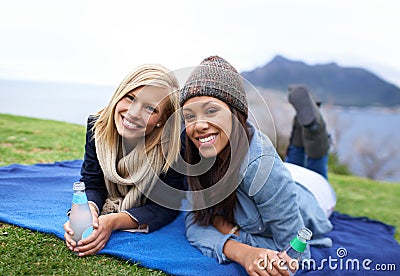 Picnic, grass and portrait of women in field with smile, happy and relaxing on weekend outdoors. Friends, countryside Stock Photo
