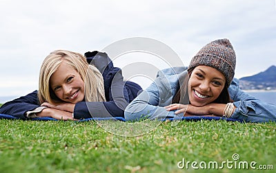 Picnic, grass and portrait of women relax in field with smile, happy and relax on weekend outdoors. Friends, countryside Stock Photo