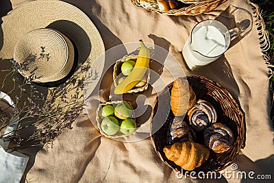 Picnic, laid out on a towel food, milk, fruits and bakery products. view from above Stock Photo