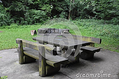 Picnic place in forest benches and table of wood in the woods Stock Photo