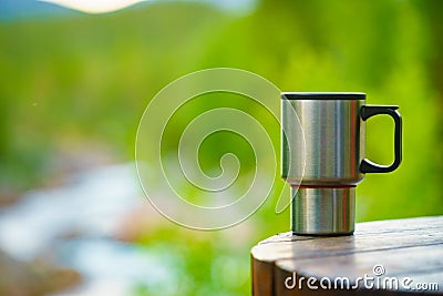 Picnic site table with thermal mug. Stock Photo