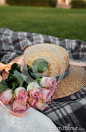 Picnic. Straw hat and flowers on the lawn Stock Photo