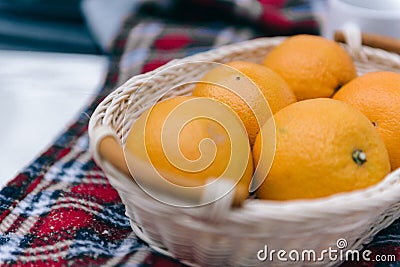 Picnic in winter. Oranges in the basket. Orange. Orange mood. Citruses. I like oranges. Fruit diet. Stock Photo