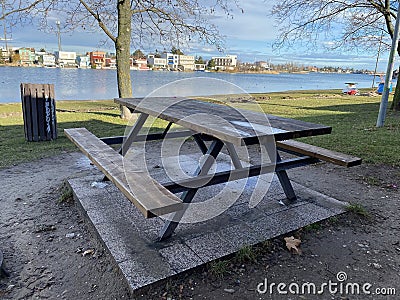 Picnic wooden table near lake Editorial Stock Photo