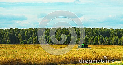 Pictorial landscape with harvester combine in field Stock Photo