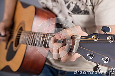 A picture of an acoustic guitar, classical color, in the hands of a guitarist Stock Photo