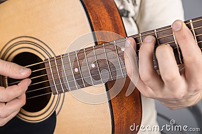 A picture of an acoustic guitar, classical color, in the hands of a guitarist Stock Photo