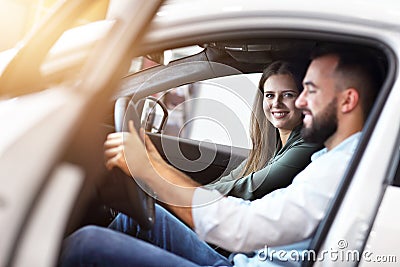 Adult couple choosing new car in showroom Stock Photo