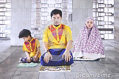 Asian family doing Salat in the mosque Stock Photo