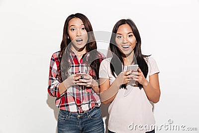 Asian surprised women sisters chatting Stock Photo