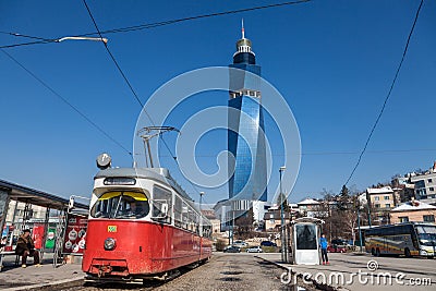 Tram ready for departure on the train station stop, the Avaz Twist Tower is seen in the background. Editorial Stock Photo
