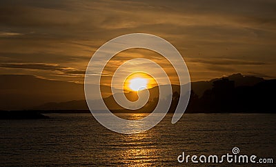 A sunset in a Cambrils beach. Sunlight crossing the water. Stock Photo