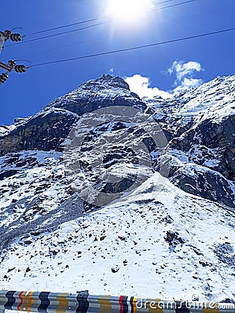 Picture captures a breathtaking winter landscape, featuring a majestic snow-capped mountain Stock Photo