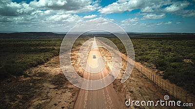 A car on a dirt road leading to the Addo Elephant National Park, near Port Elizabeth from a drone Stock Photo