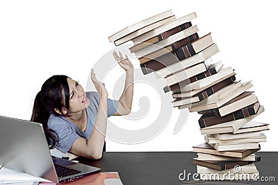 Caucasian student with falling books on studio Stock Photo